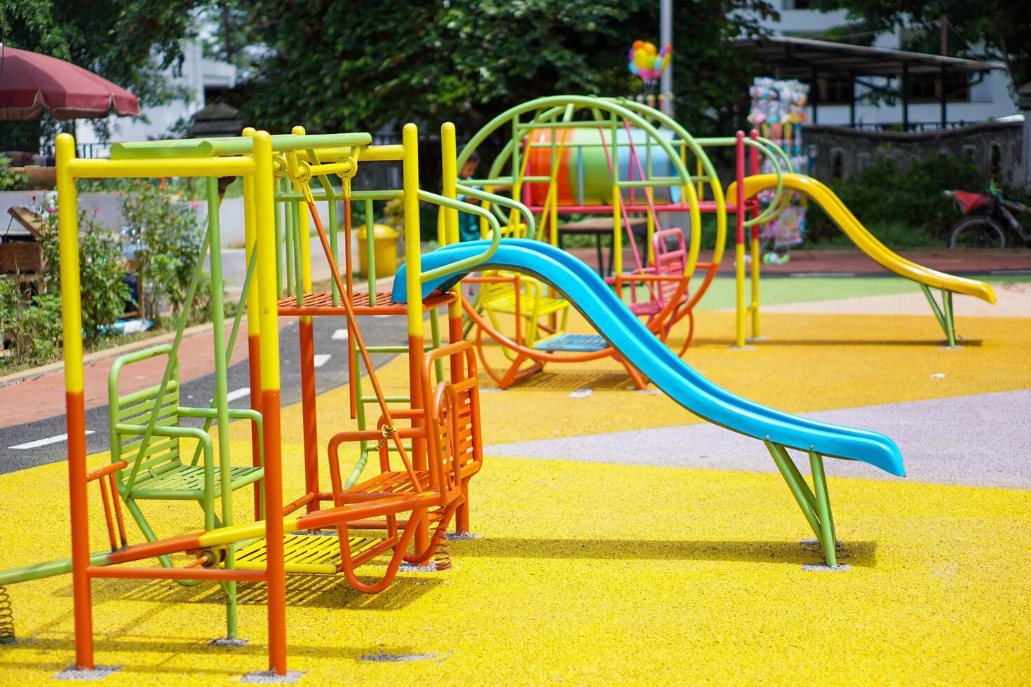 A colorful playground with slides, swings, and climbing structures, perfect for children's outdoor fun. photo