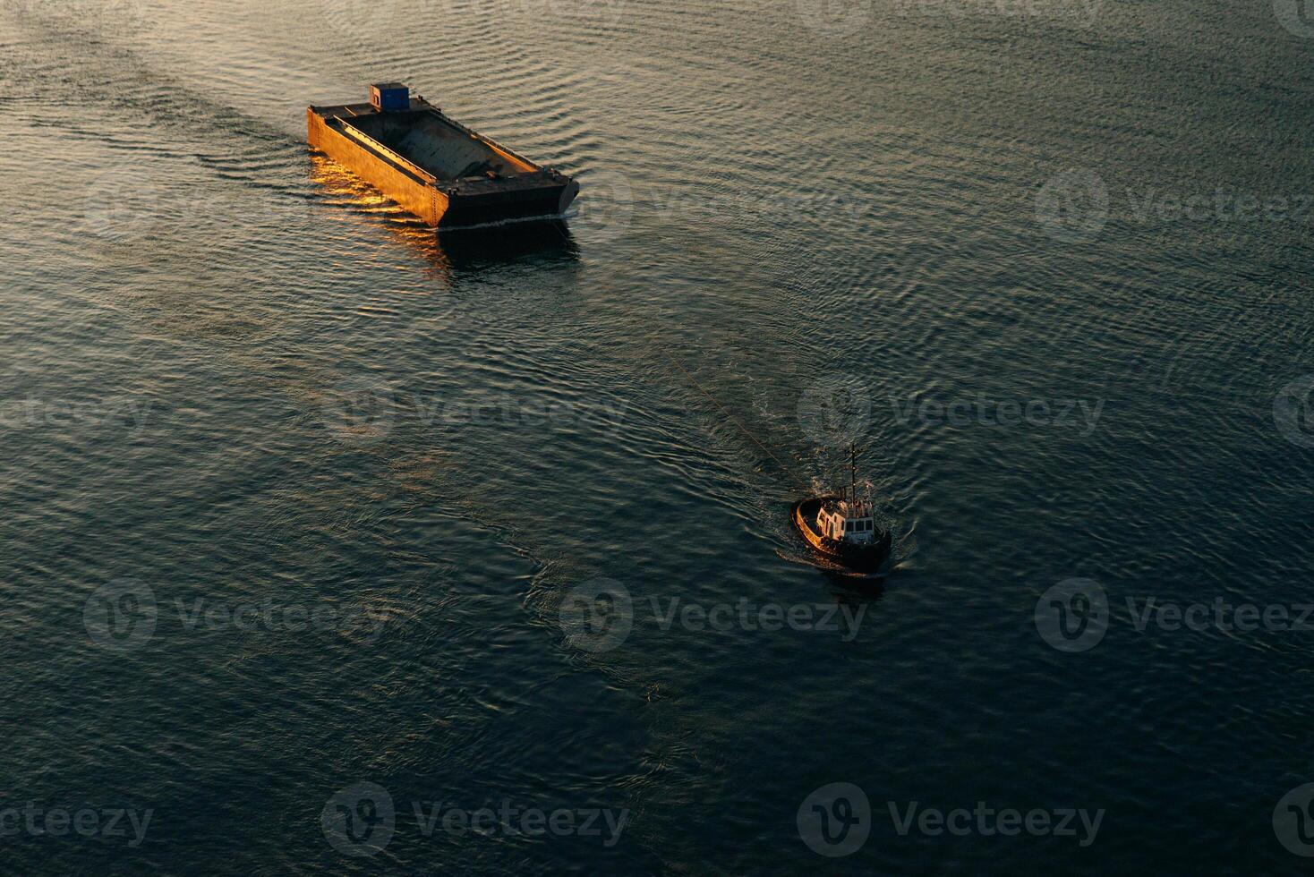 Canadian tugboat departing Vancouver, canada with an Empty rock barge in tow. photo