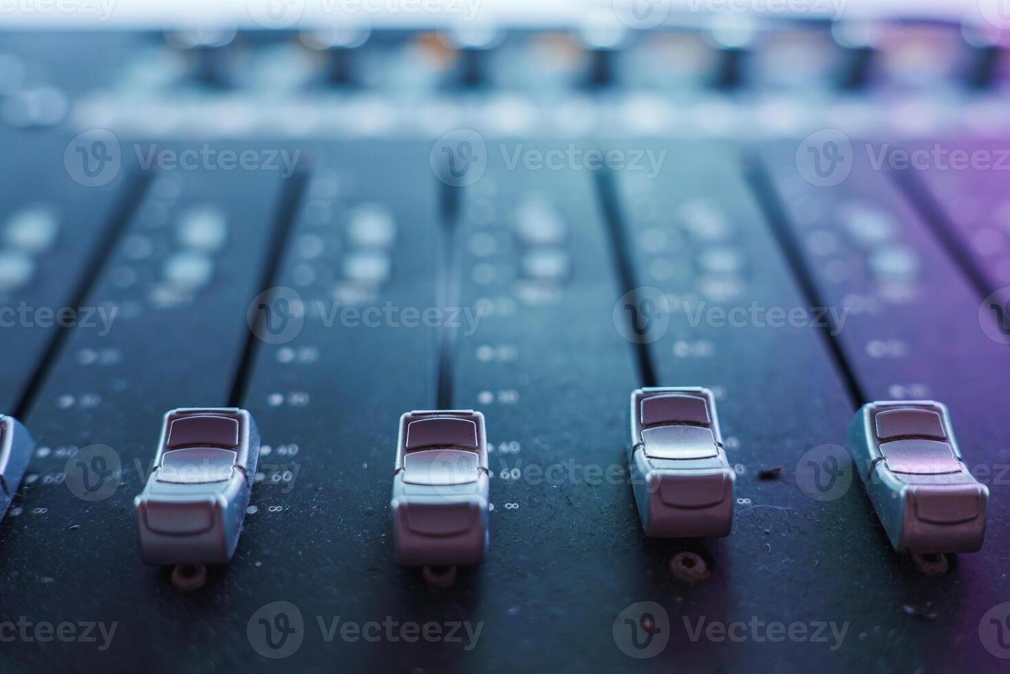 Close Up View of Audio Mixing Console with Faders in Studio photo