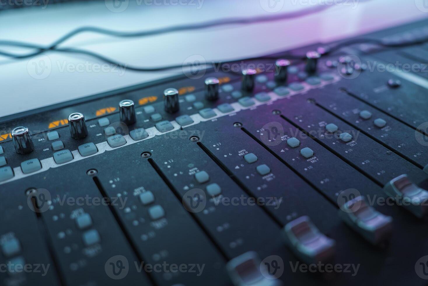 Close Up of Professional Audio Mixing Console in Studio Lighting photo