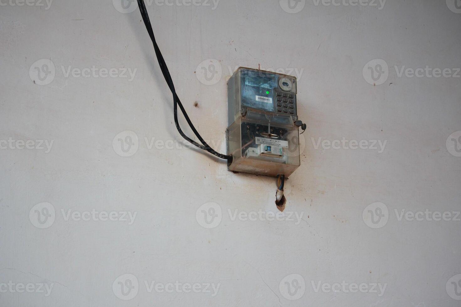 Electric Meter Installation on Wall with Protective Cover and Wiring System photo