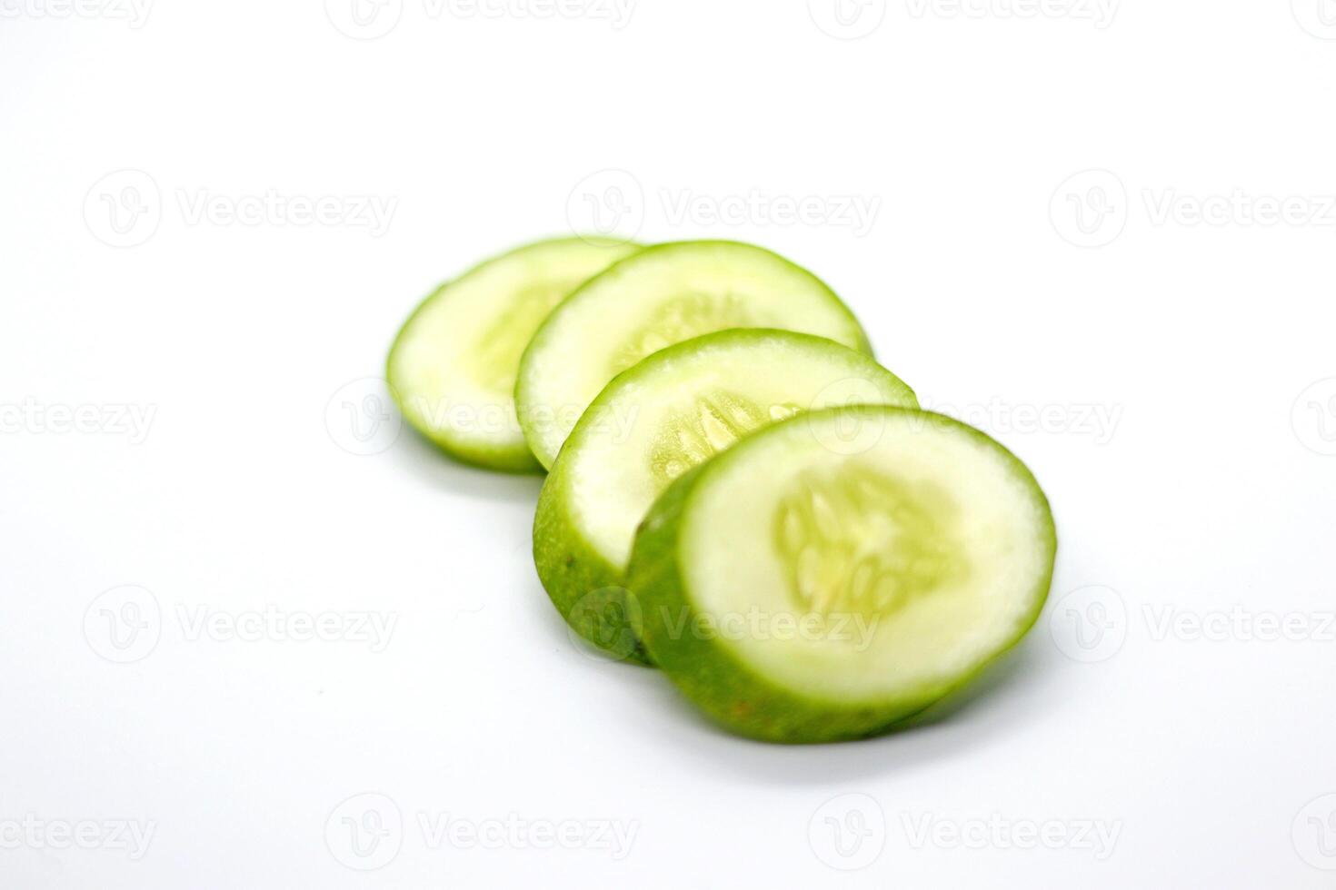 slices of fresh green cucumber. isolated white background. photo