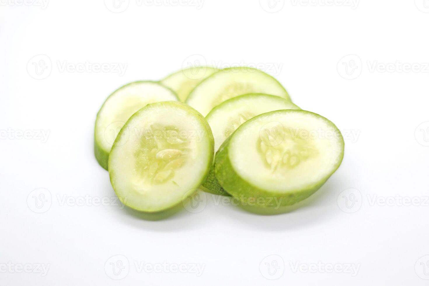 slices of fresh green cucumber. isolated white background. photo