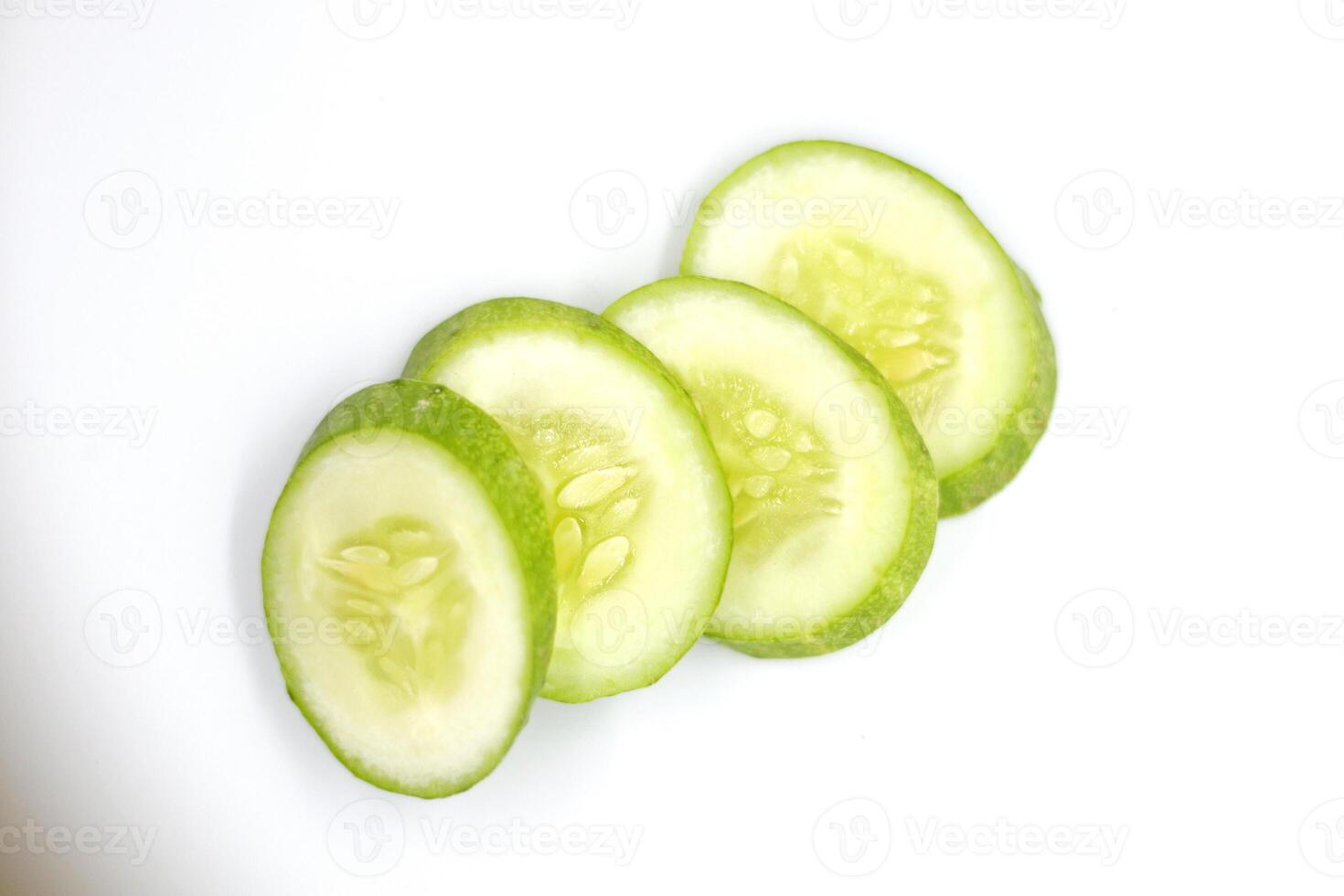 slices of fresh green cucumber. isolated white background. photo