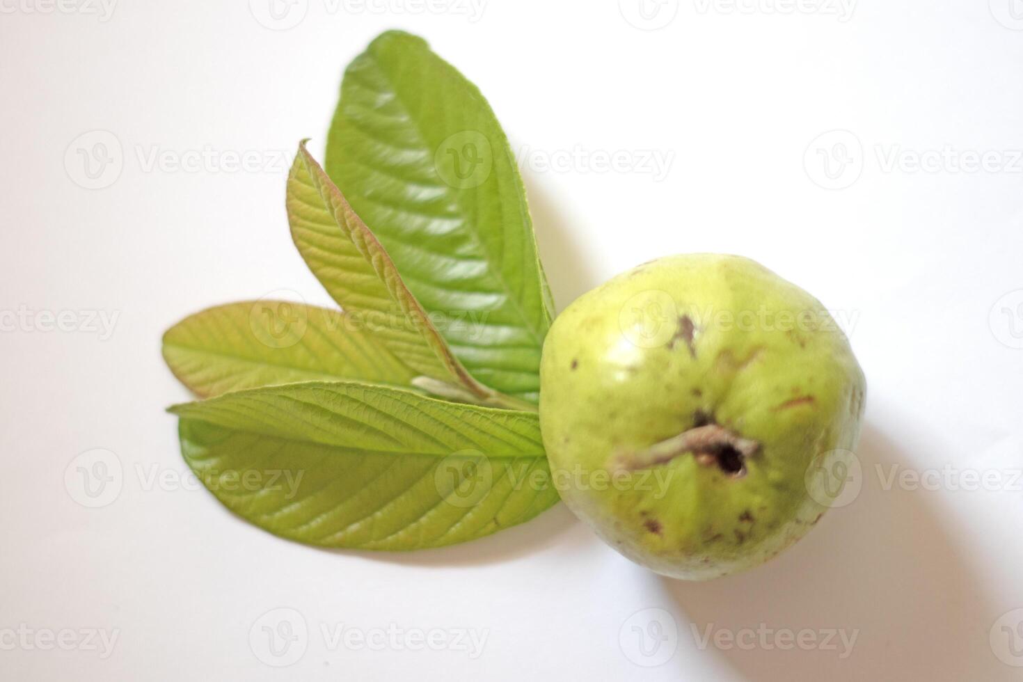 Pink guava with green leaves and slices isolated on white background, top view, flat. photo