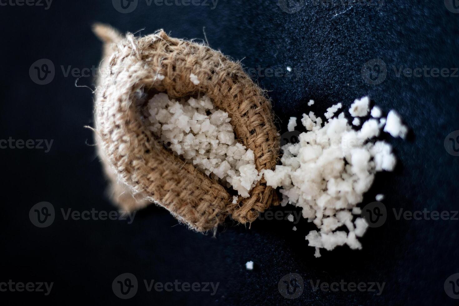 Sea salt coming out of a burlap sack photo