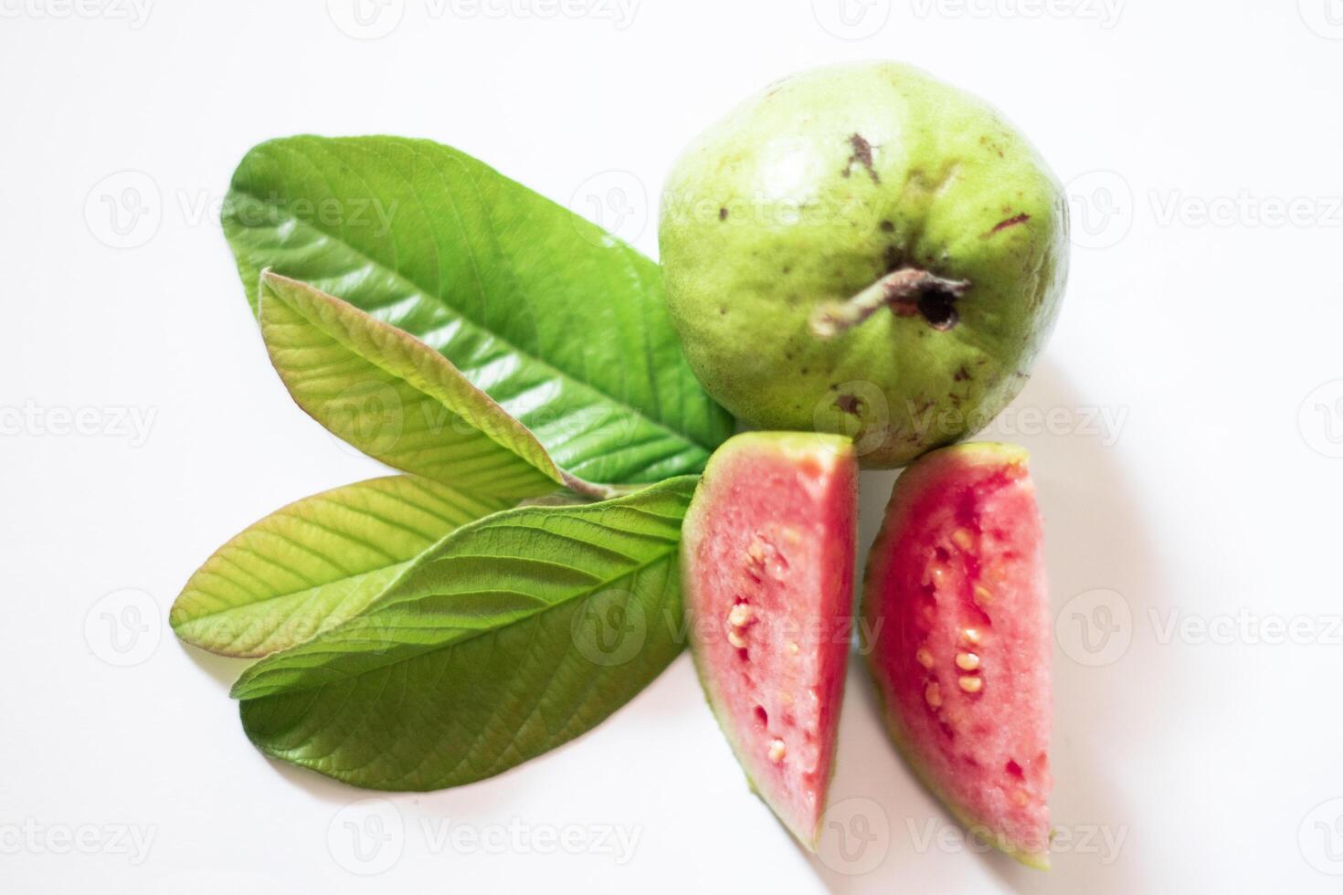Pink guava with green leaves and slices isolated on white background, top view, flat. photo
