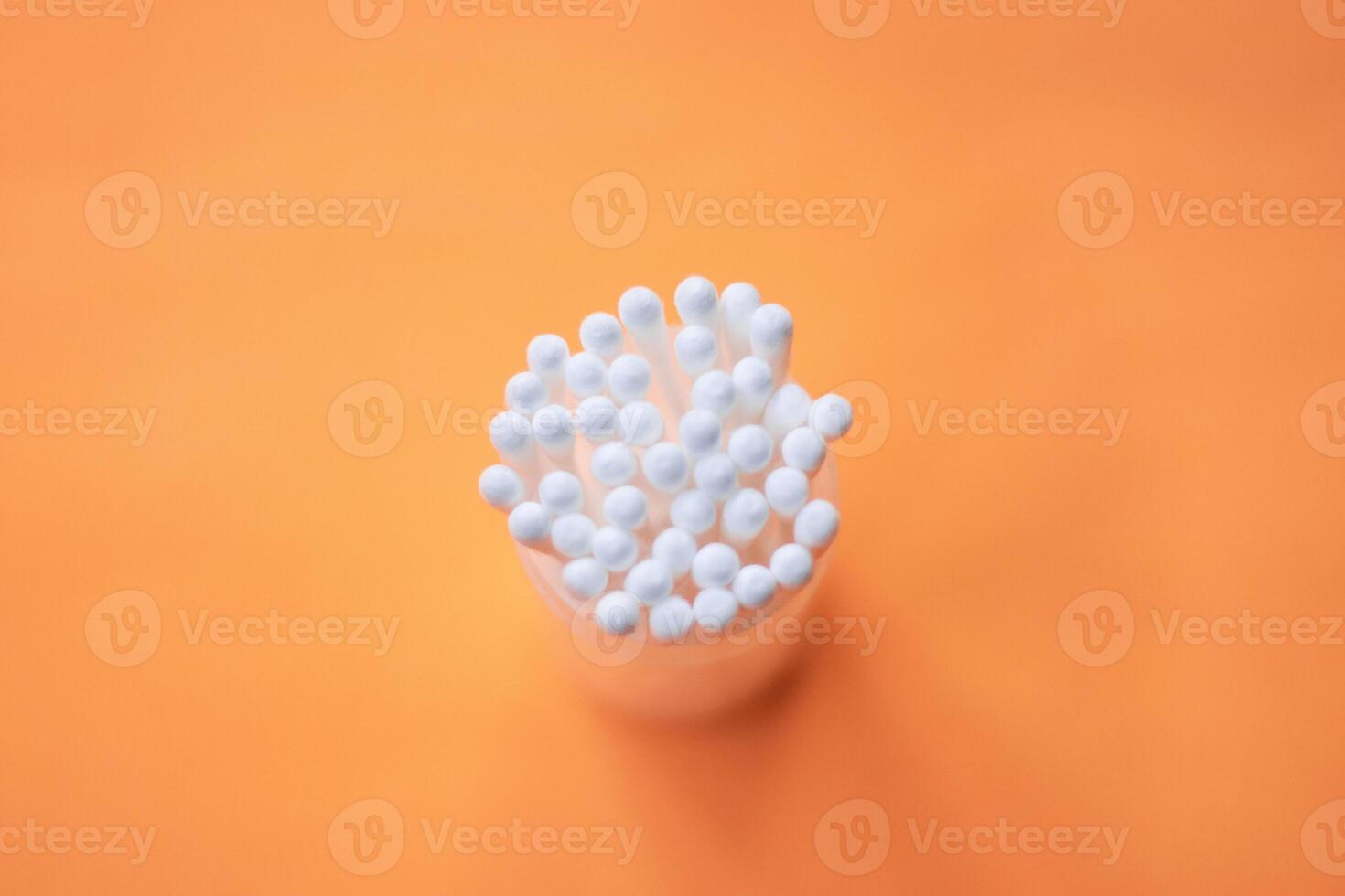Plastic jar with clean cotton wool isolated on white photo