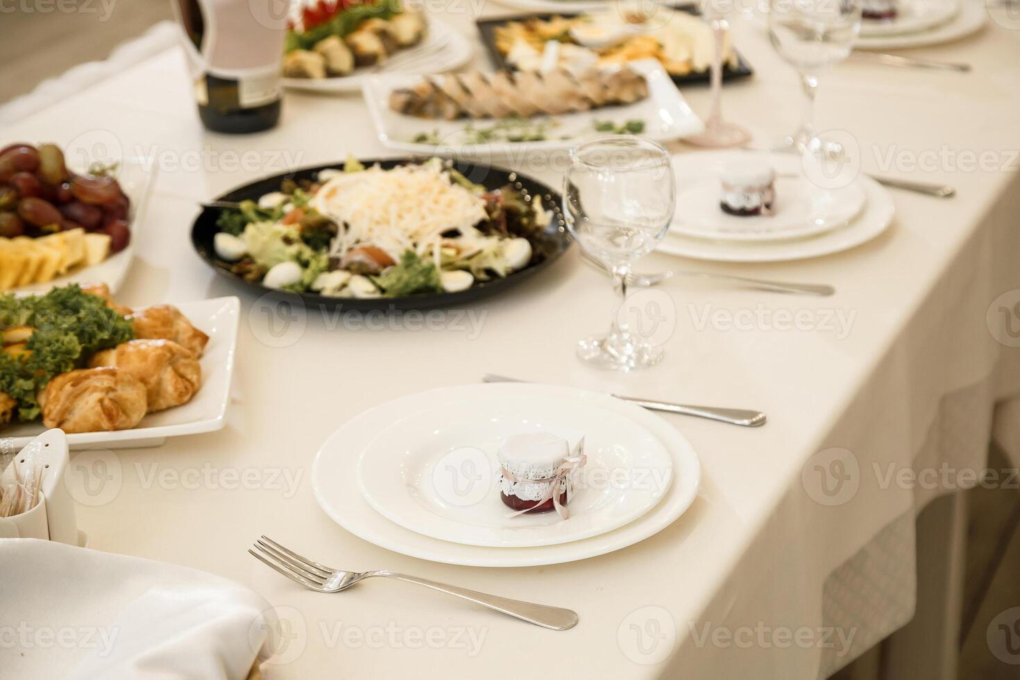 Nicely decorated banquet table with a variety of snacks and sandwich appetizers photo