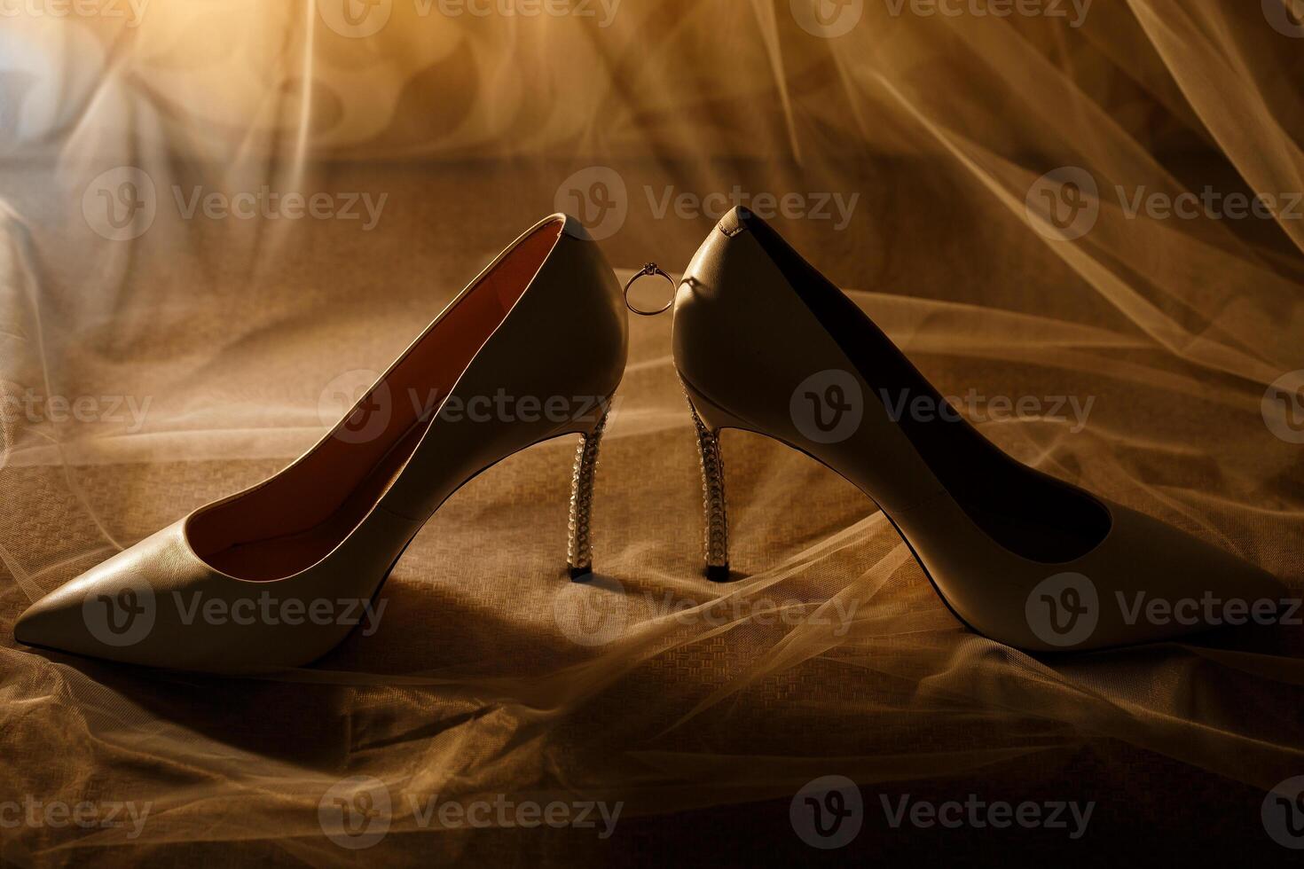 Gold wedding ring with women's shoes on the wedding day photo