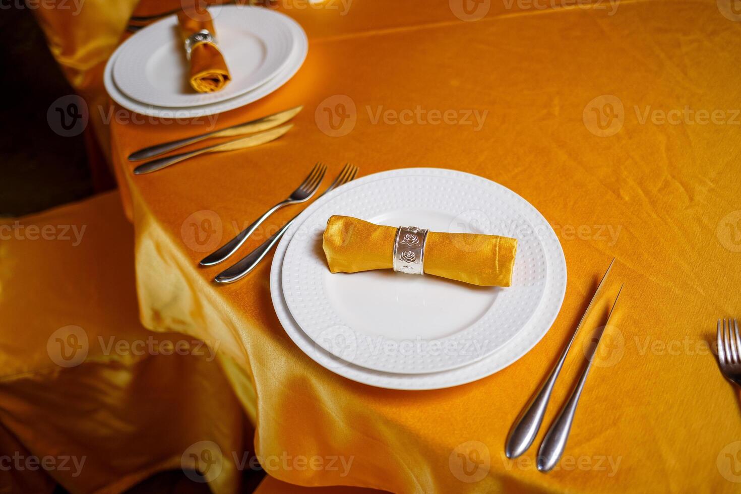 Elegant table setting with fork, knife and gold napkin photo