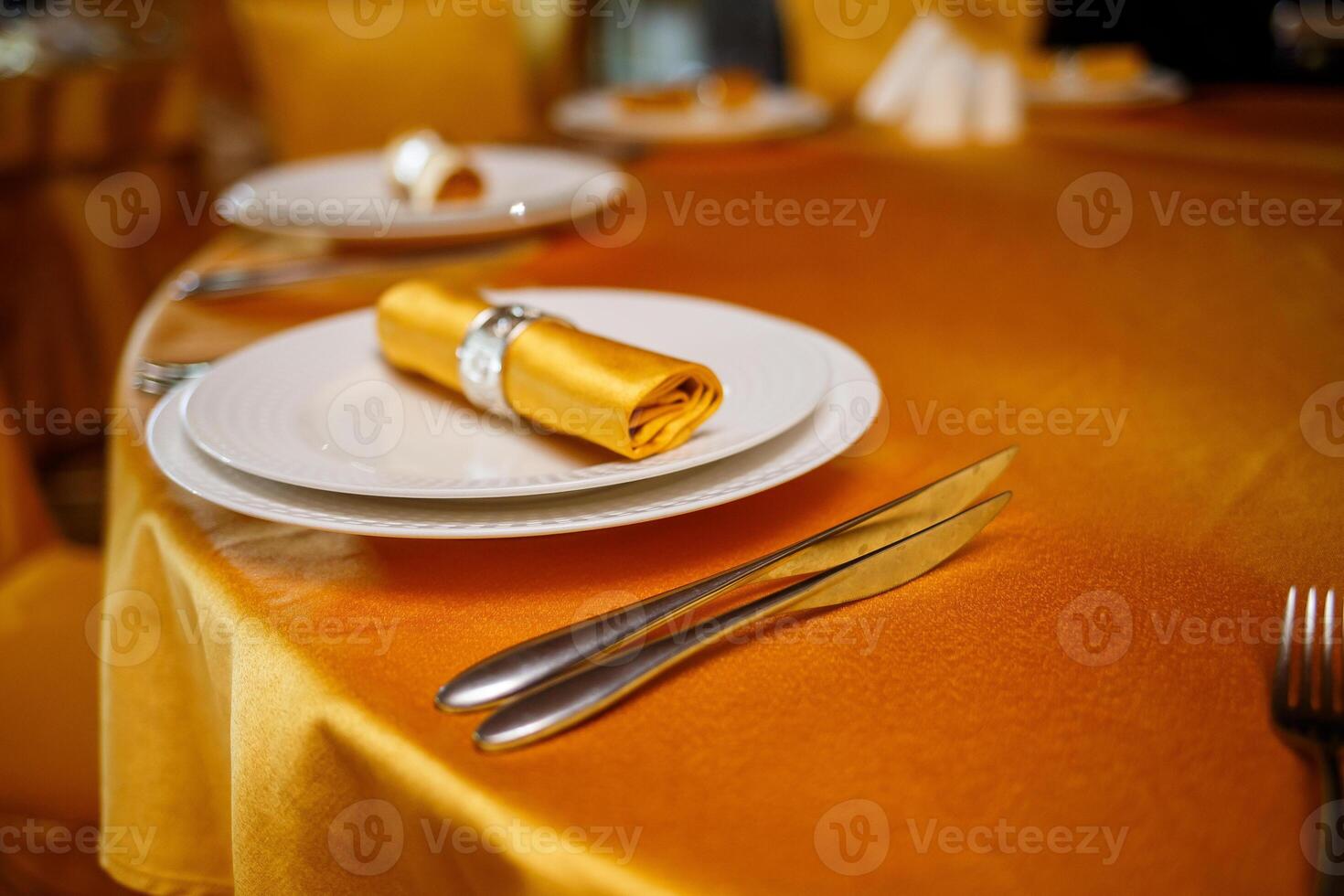 Elegant table setting with fork, knife and gold napkin photo
