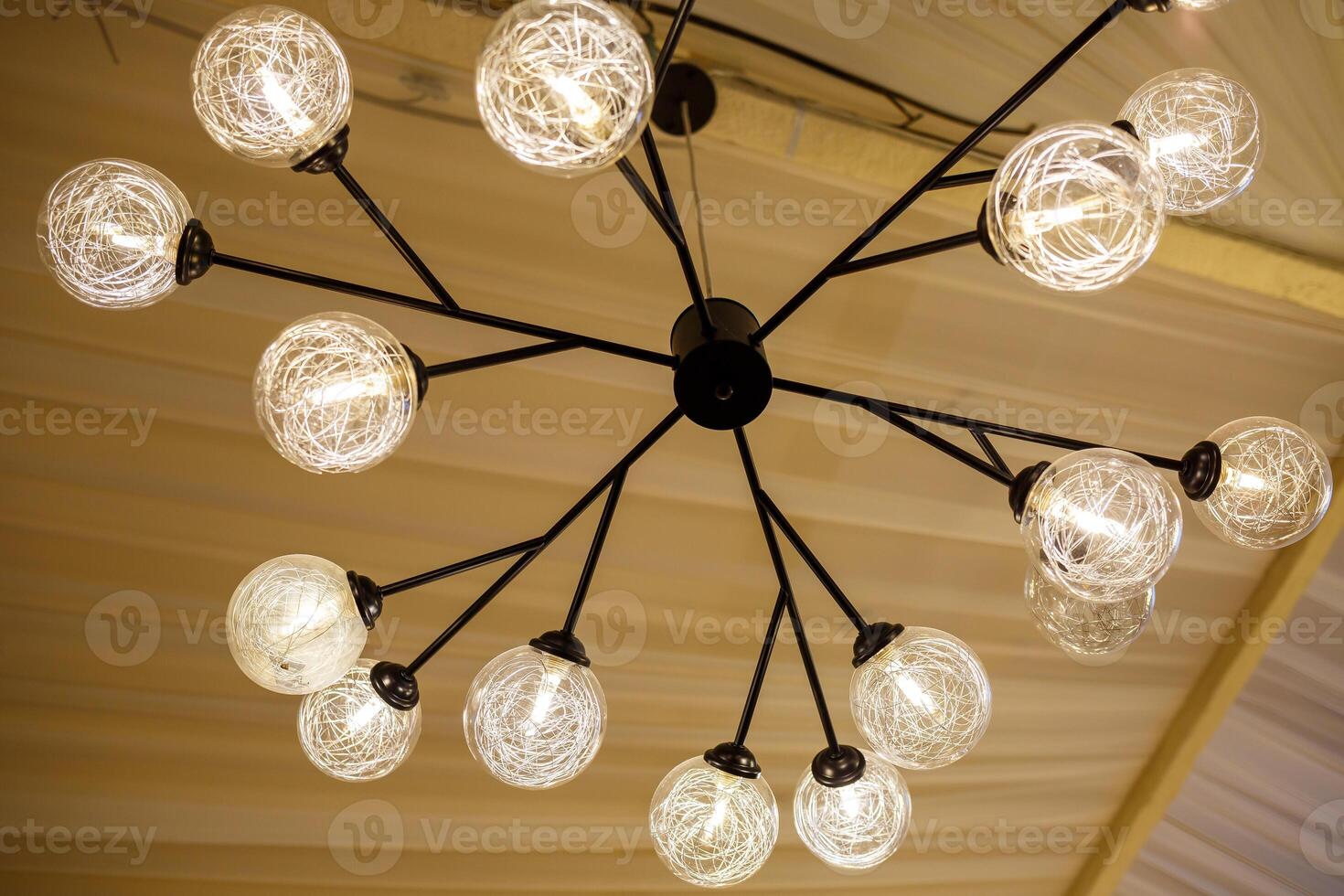 Modern loft chandelier with many shades with energy saving lamps photo