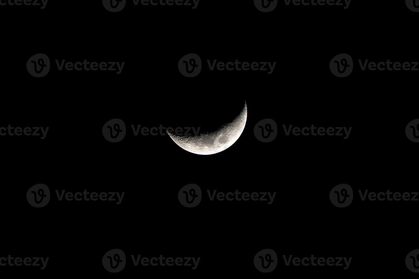 The crescent moon in the dark night sky is a beautiful and iconic sight that is often associated with mystery and magic. photo