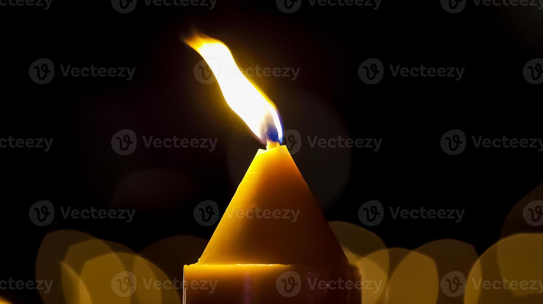The flame of the candle is yellow, and the candle is huge. photo