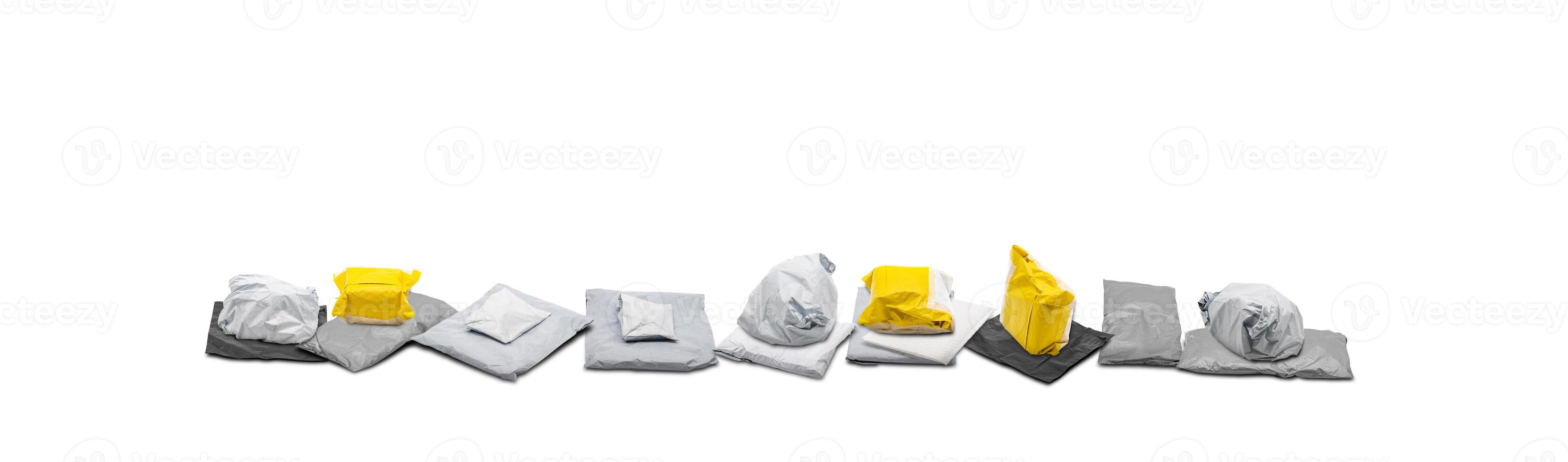 The gray and yellow shipping parcel bags were arranged in a line on a white background shot in a studio. photo