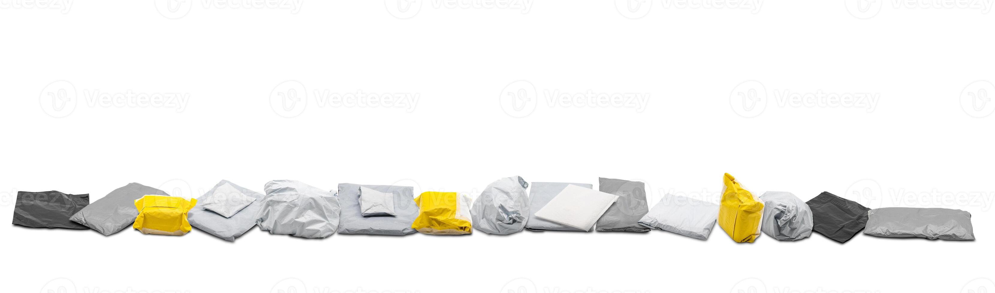 The gray and yellow shipping parcel bags were arranged in a line on a white background shot in a studio. photo