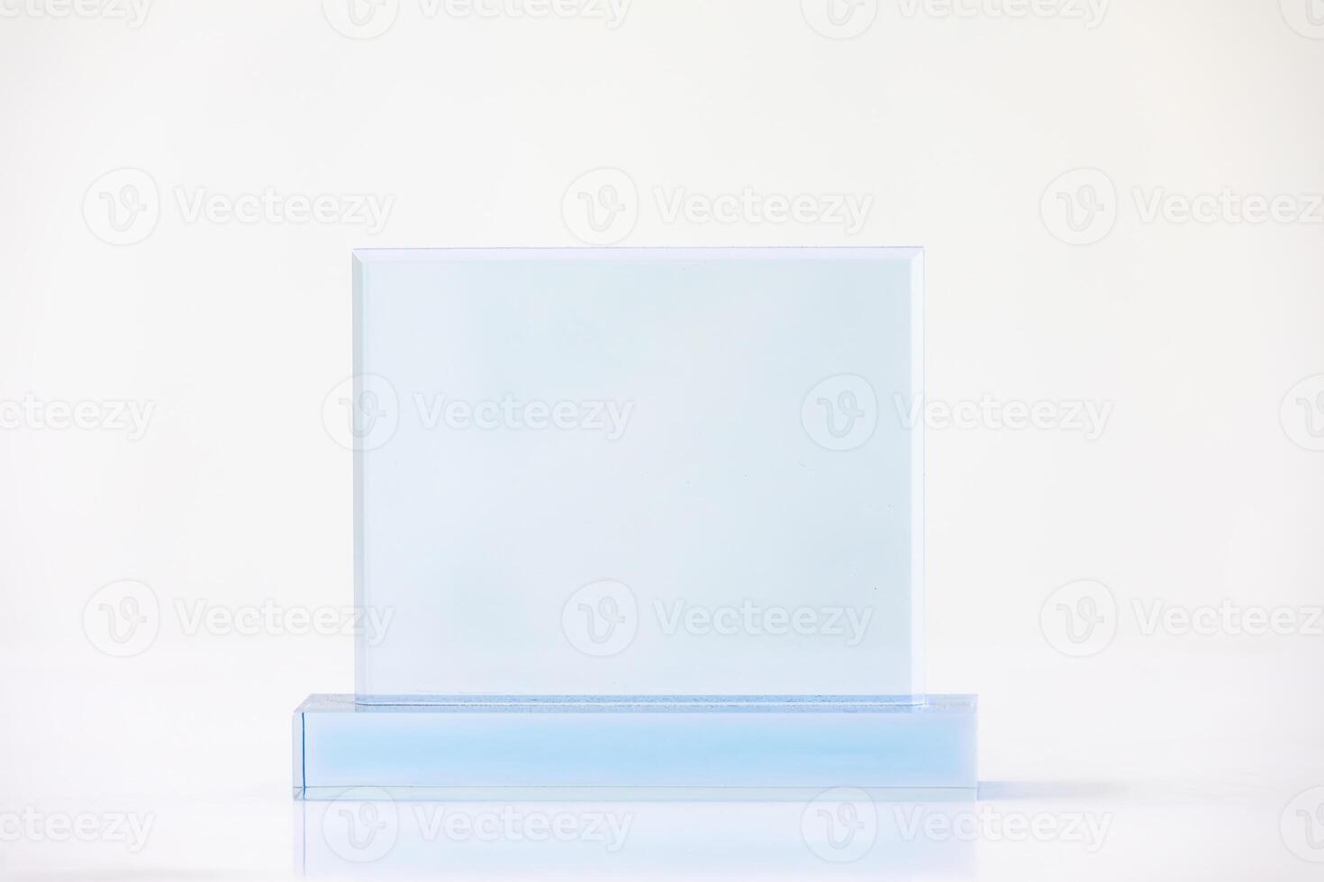 The shot of the blank transparent glass award trophy on a white background, the custom laser cut of the transparent crystal prize. photo