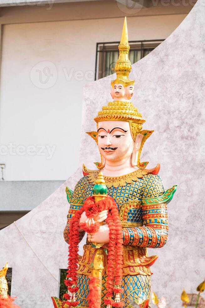 Majestic statue of Thao Wessuwan, the Asian deity of wealth and protection, showcased in the sacred surroundings of Wat ThepLeeLa temple in Bangkok, Thailand. photo