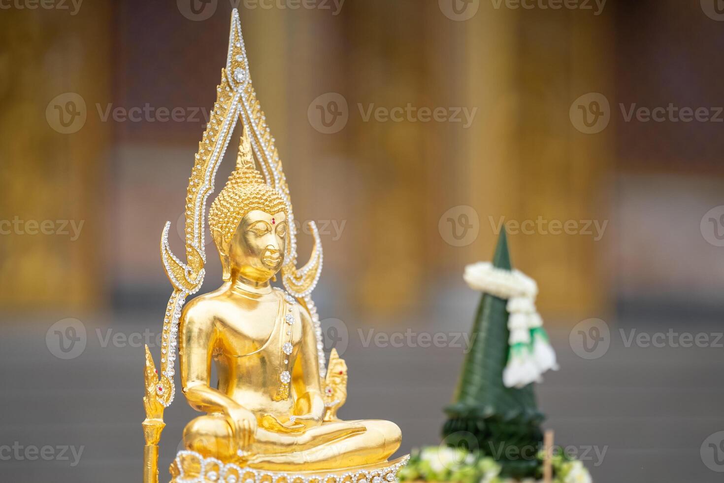 A stunning golden Buddha sculpture, exemplifying the deep reverence and devotion of Thai individuals in their spiritual worship. photo
