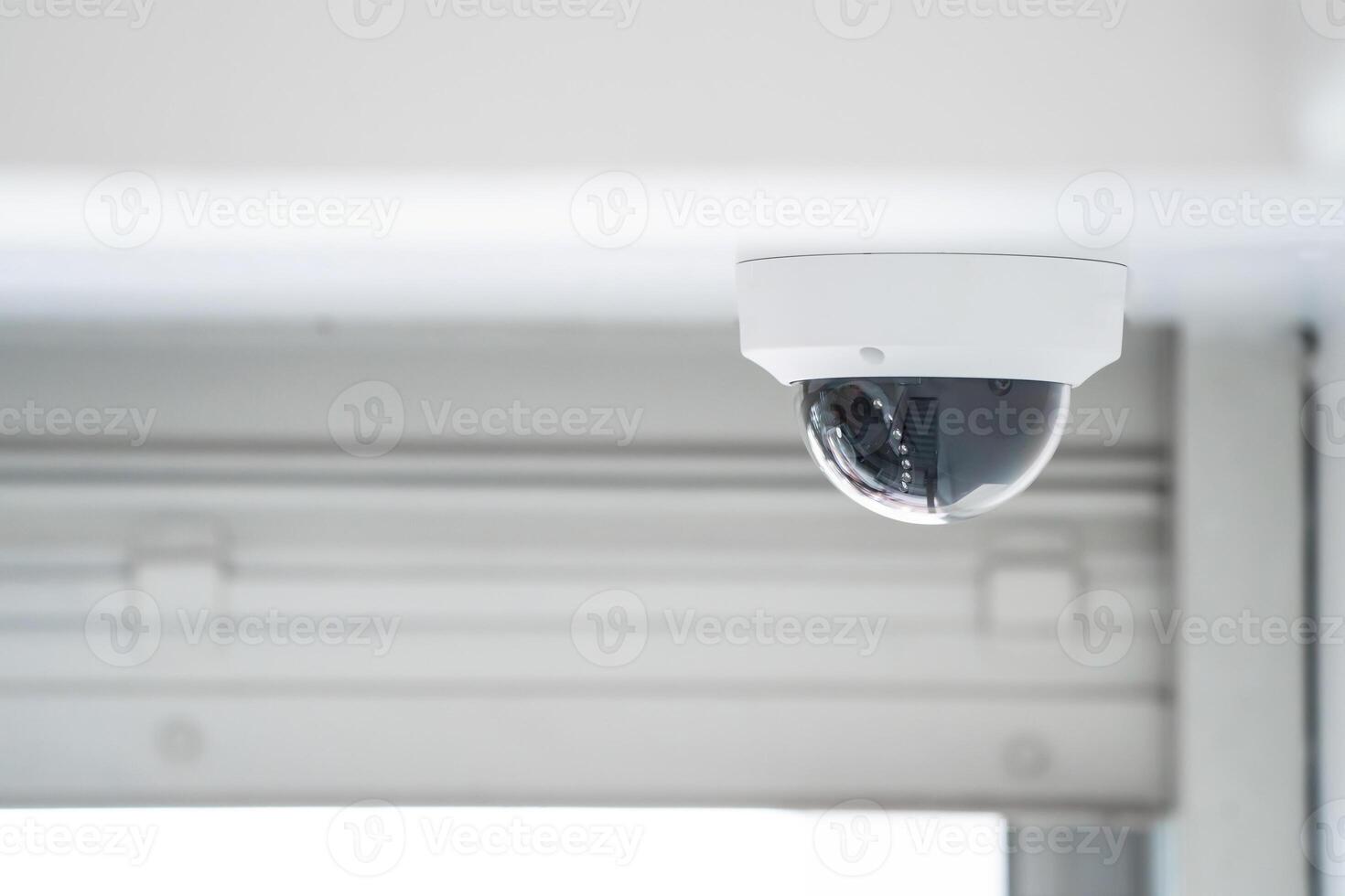 CCTV camera is installed inside the building on the ceiling and wall for monitoring and running safety system control in that area. photo