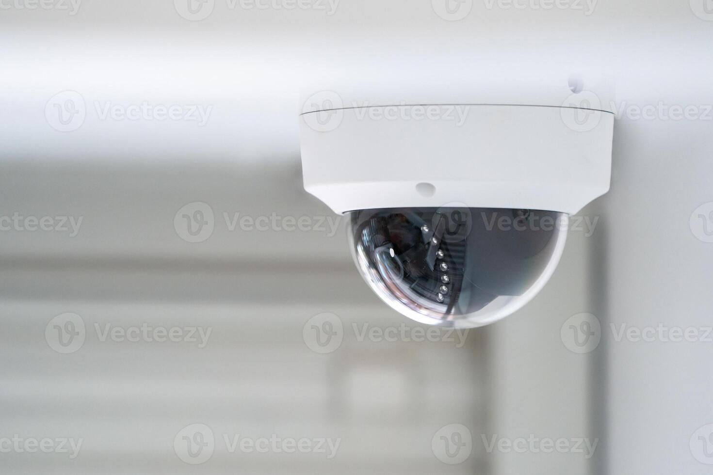 CCTV camera is installed inside the building on the ceiling and wall for monitoring and running safety system control in that area. photo