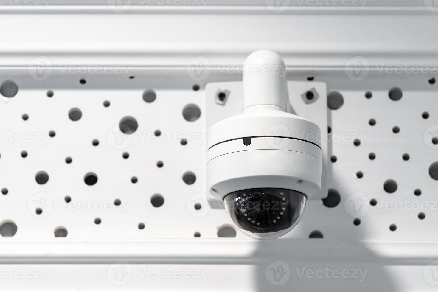 CCTV camera is installed inside the building on the ceiling and wall for monitoring and running safety system control in that area. photo