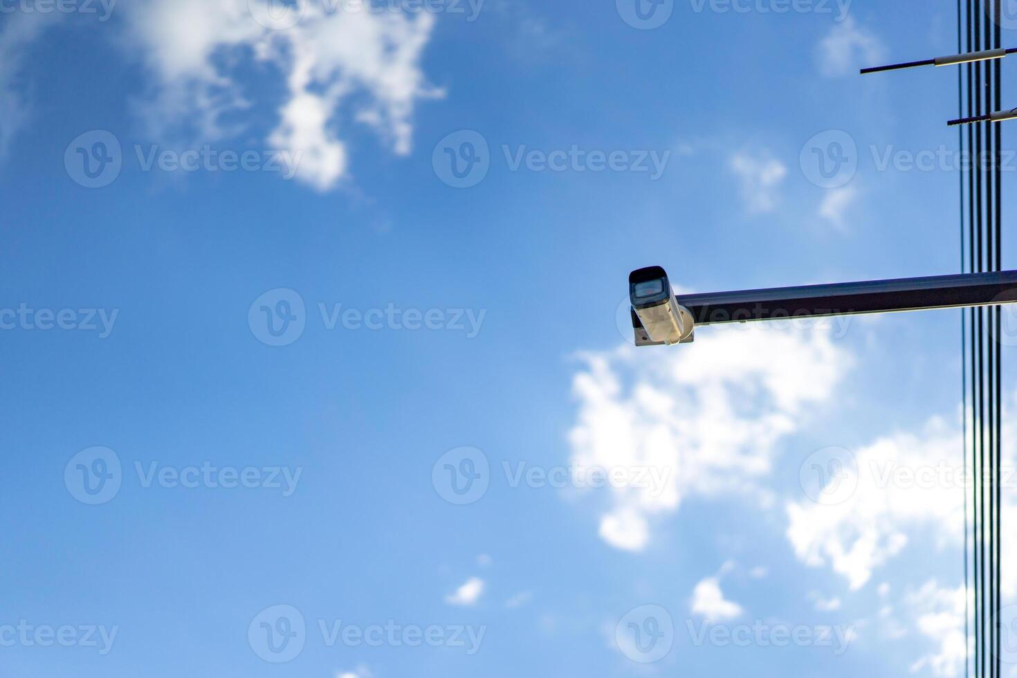 cctv camera is installed on the Metal stick that hung on to electric pole beside the street in village for monitoring and running safety system control in that area. photo