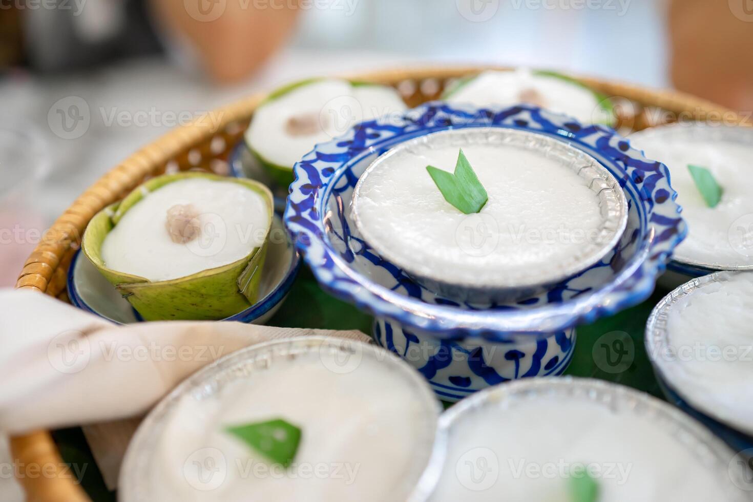 Luxury Dessert, Khanom thuai is Thai dessert coconut milk pudding was arranged in the wicker set on the marble table. photo