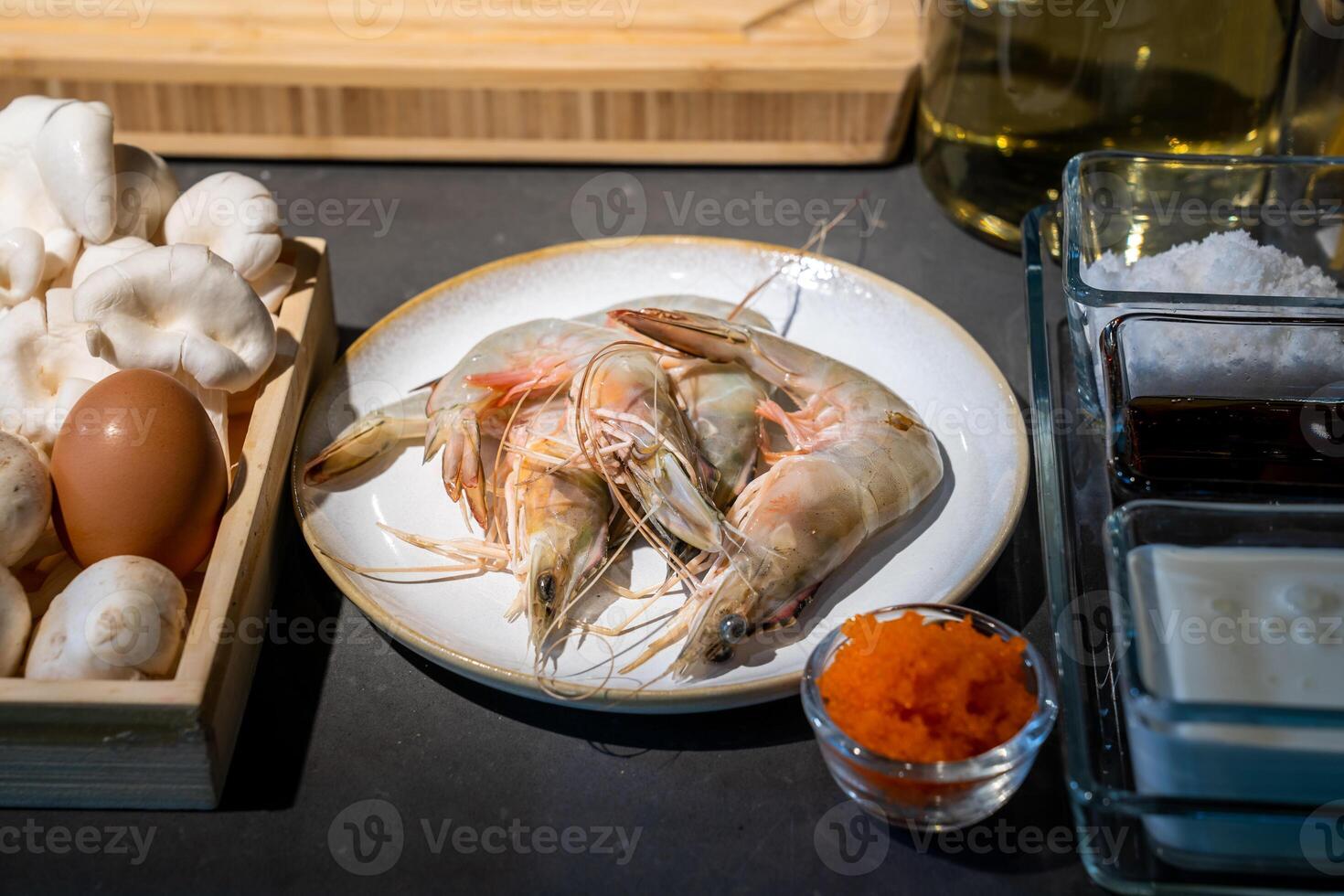 Focused on Shrimp in among of ingredients, mushroom, egg, sauce, tobiko, for meal cooking. photo