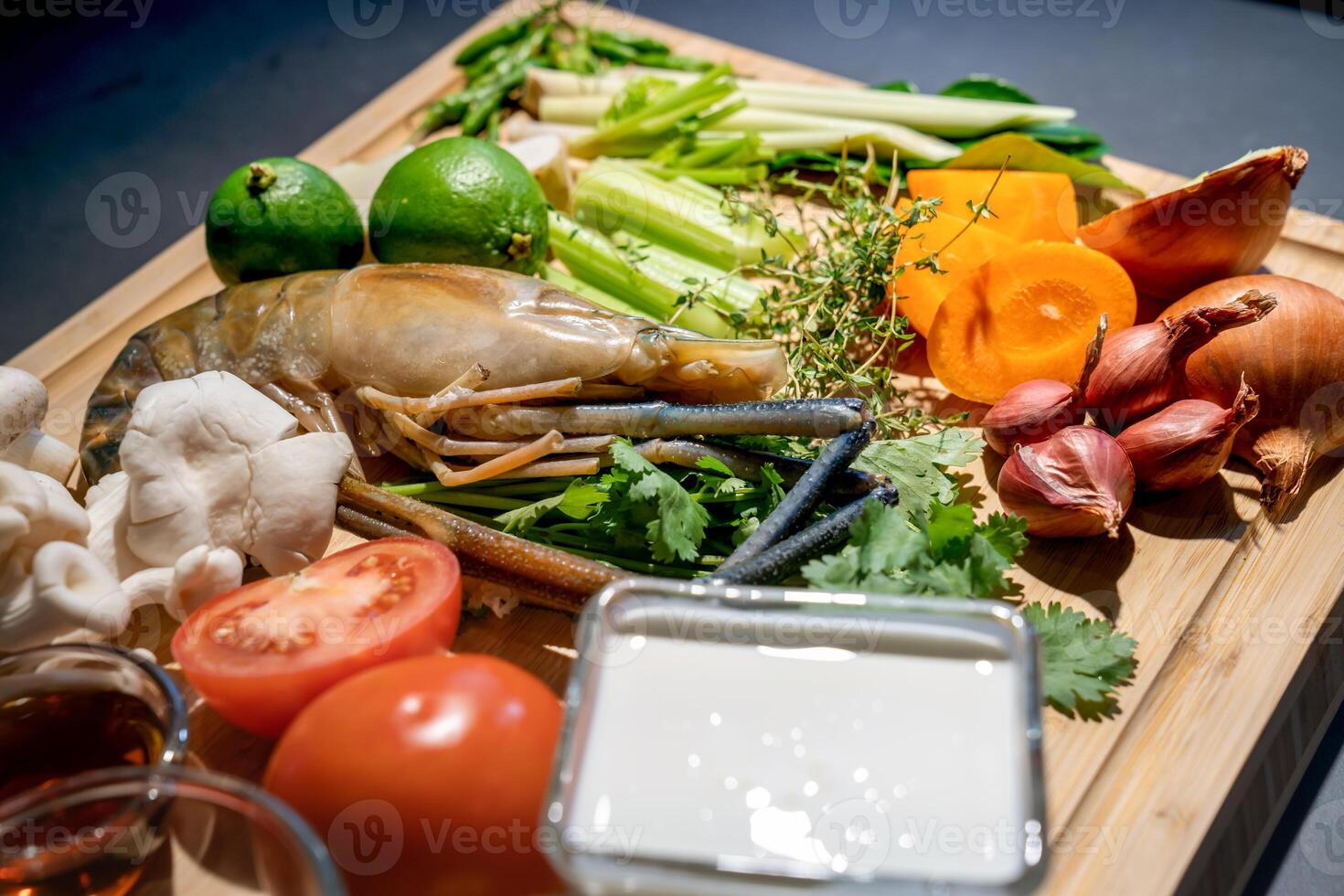 Close up the Ingredients set of TomYamKung Shrimp Spicy Thai Soup is a prawn, lemon condiment sauces and the others on the kitchen counter. photo