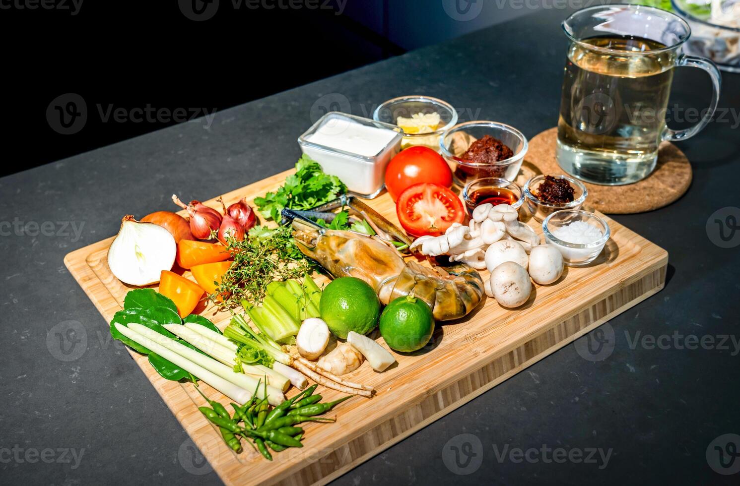 Flatlay Tabletop Ingredients of TomYamKung Shrimp Spicy Thai Soup is a prawn, lemon condiment sauces and the others on the kitchen counter. photo