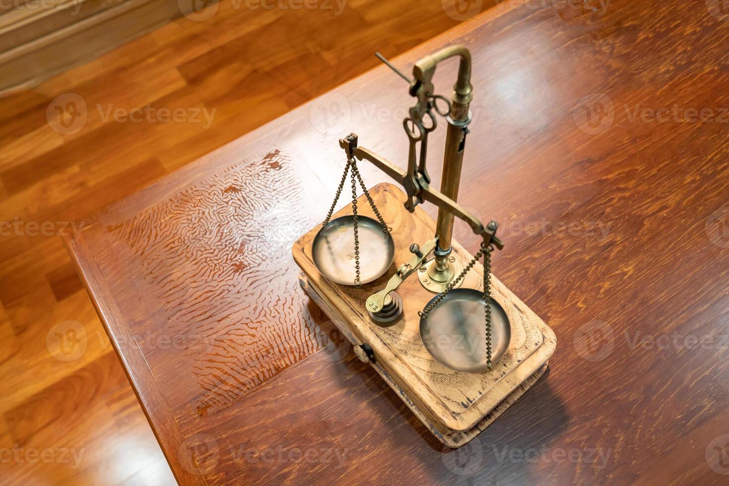 Flatlay Toptable of Classic Golden Scale in vintage mood and tone lays on wooden table. photo