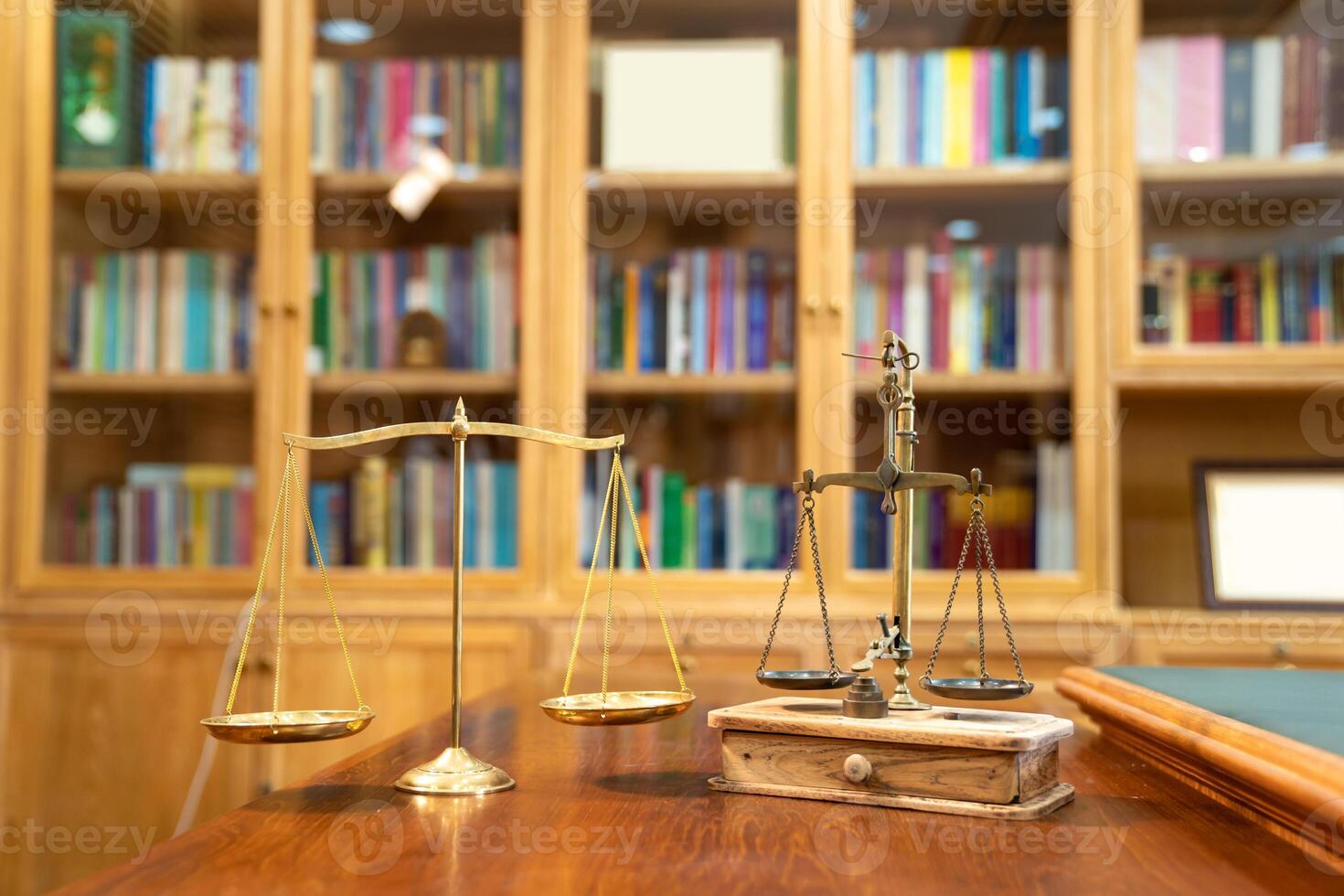 Comparison between Gold Vintage and Modern scale lay on wood table in front of library book shelf. photo