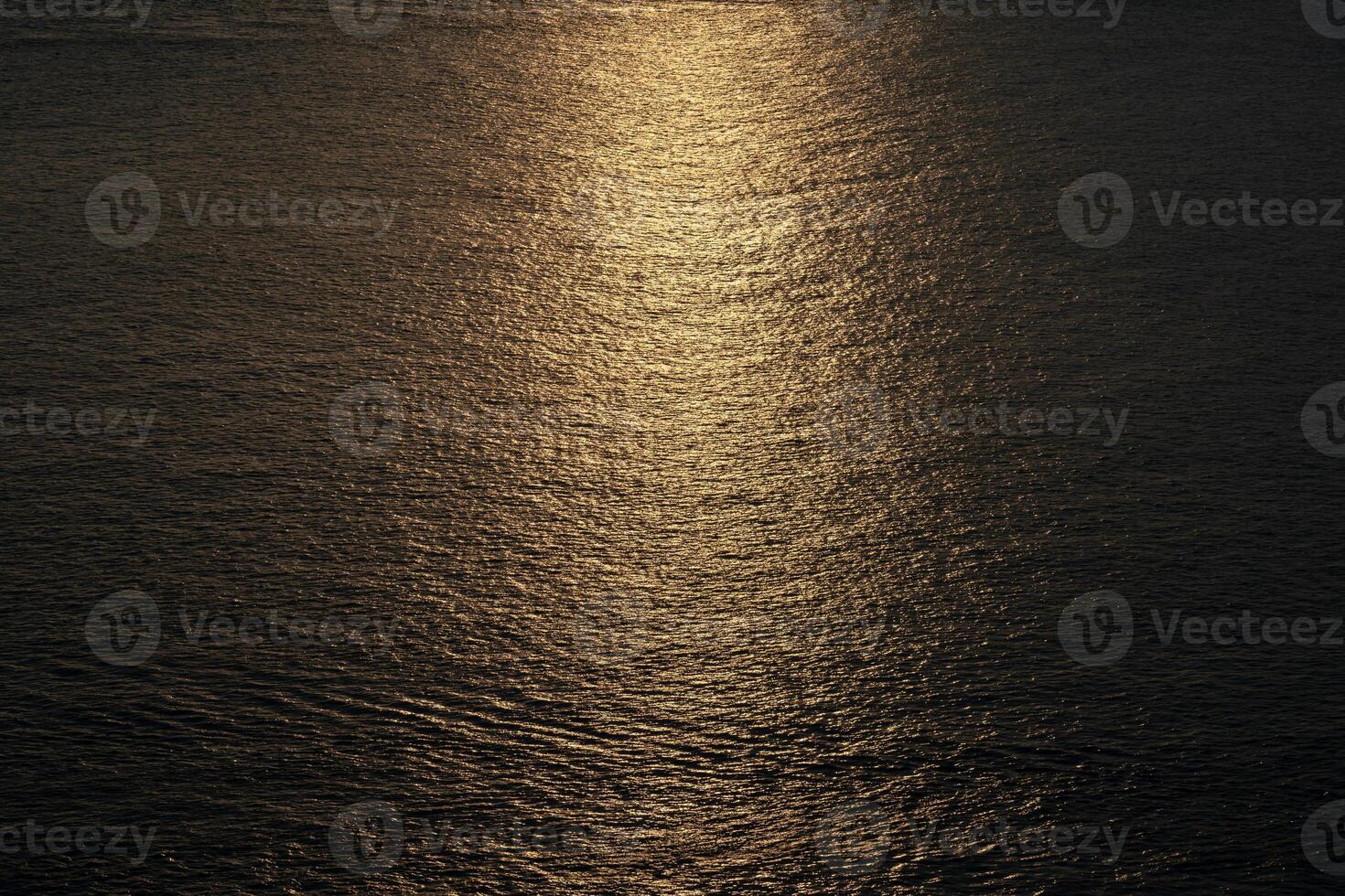 Close up to the texture of the sea surface with the abstract golden colour background in the twilight time. photo