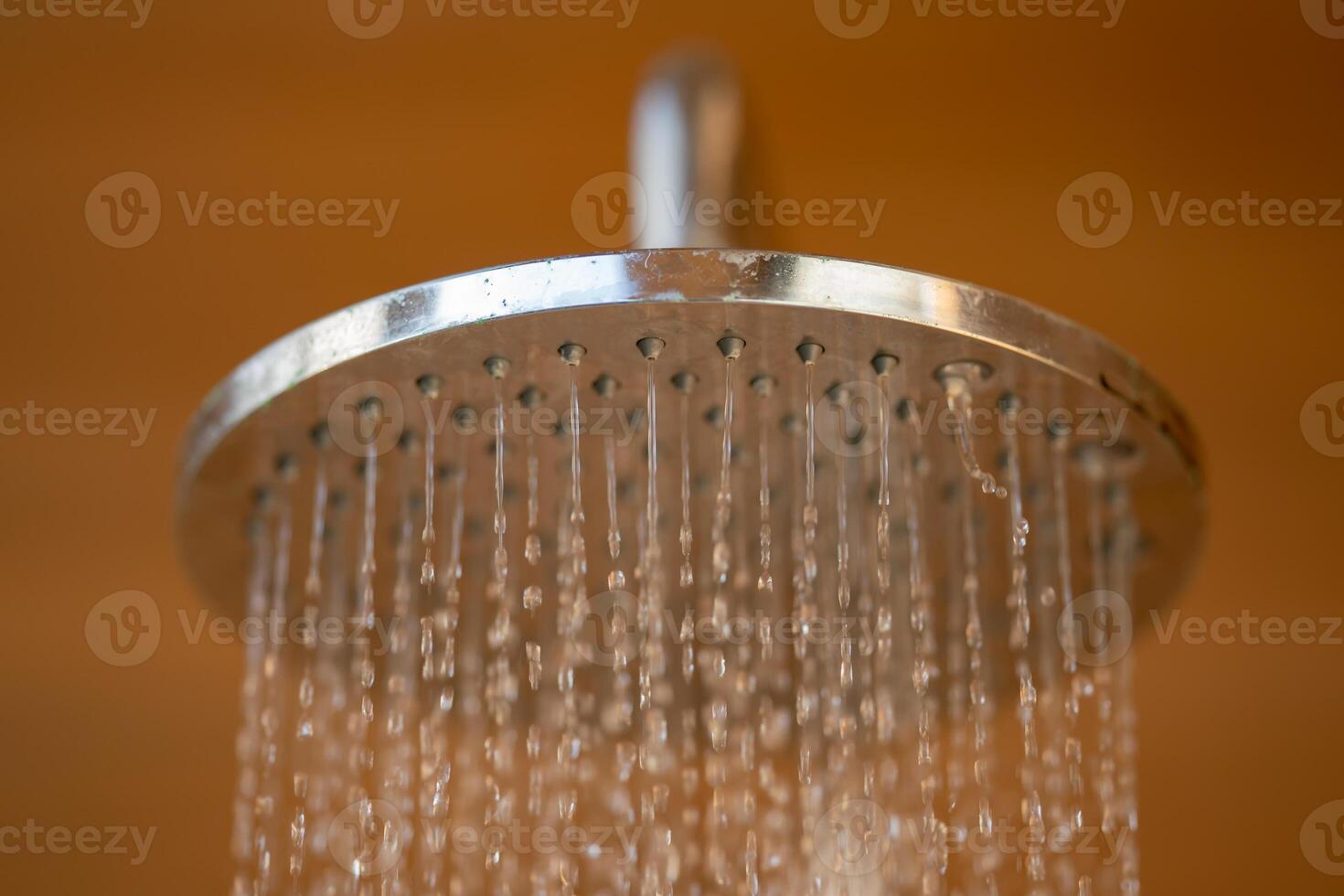 Close up to Outdoor shower head for the bath and showering cold water to body before jumping in the resort pool. photo