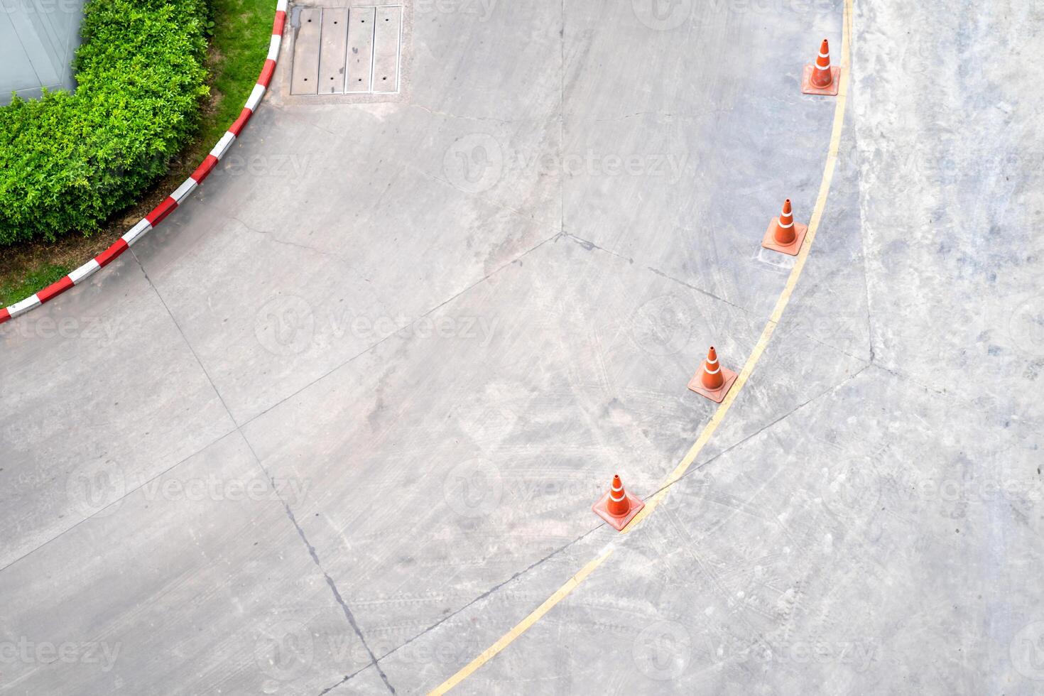 Curve street from the top view angle with yellow line and traffic cone on the line. photo