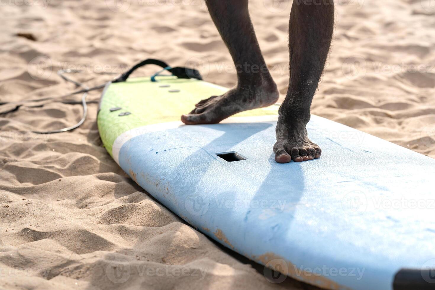 An example position of Asian professional feet on a surfboard in surfing board lesson study and training by the teacher. photo