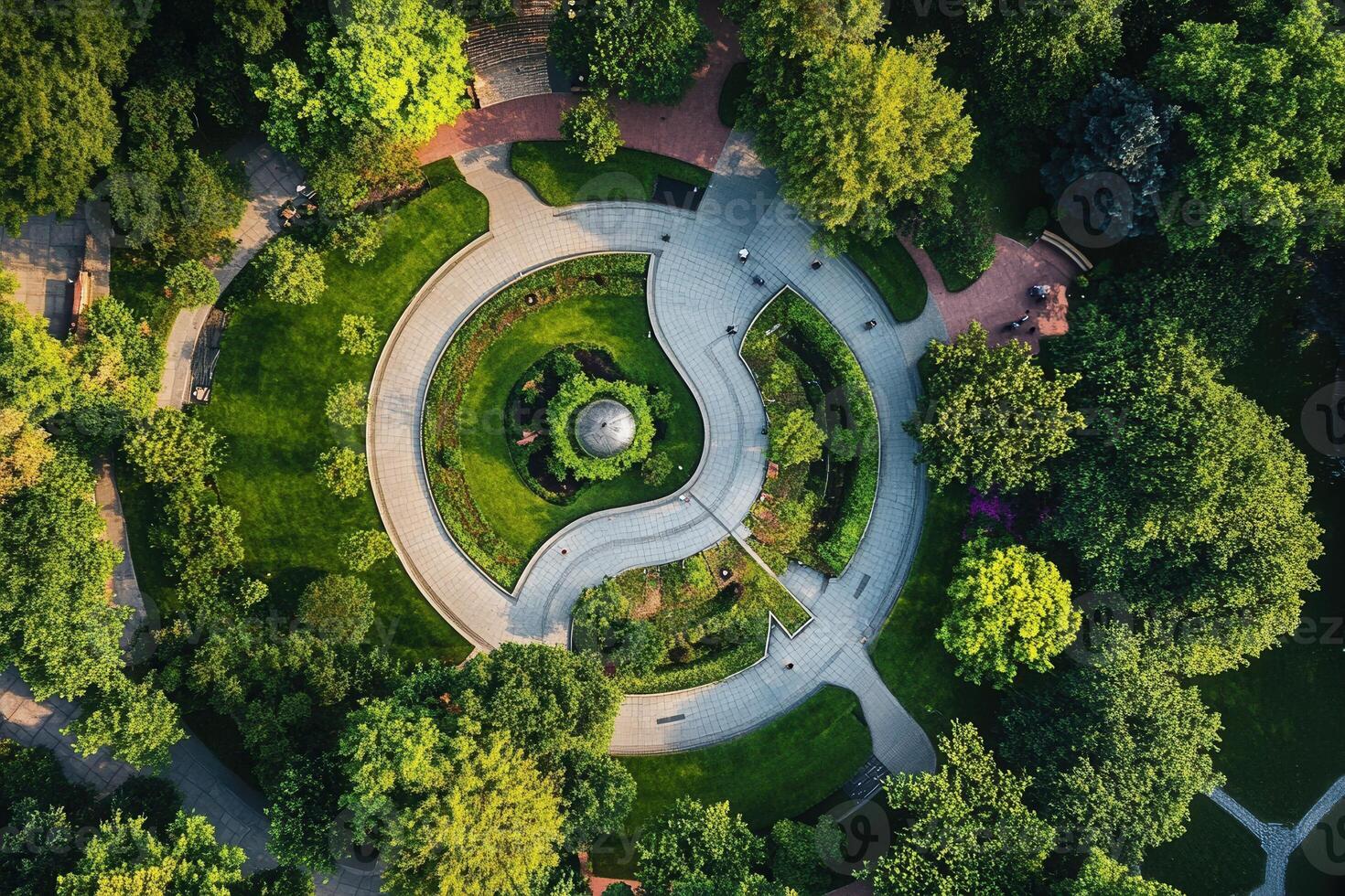 Aerial view of a circular park with lush greenery and winding pathways. photo