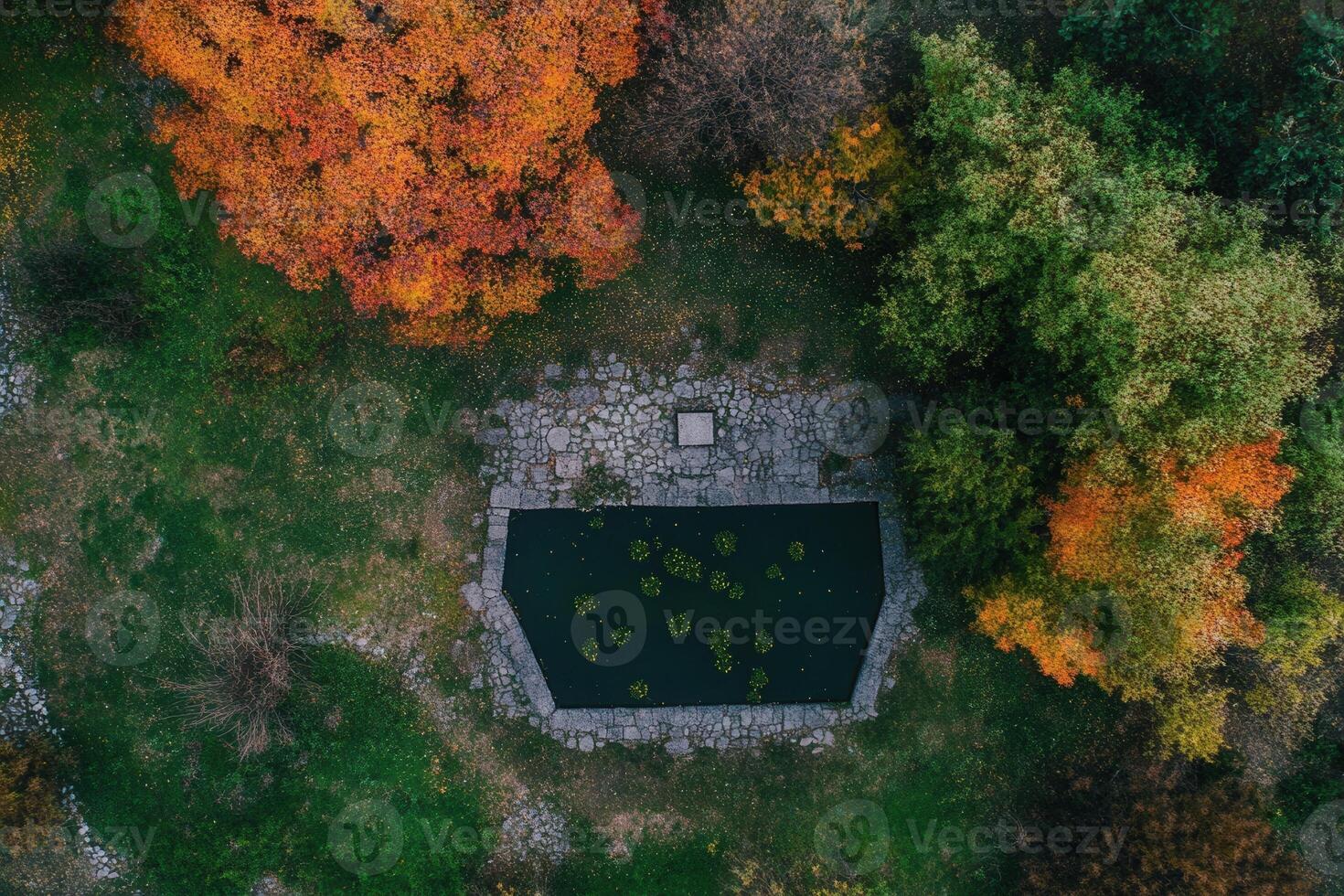 Aerial view of a stone pond in autumn forest. photo