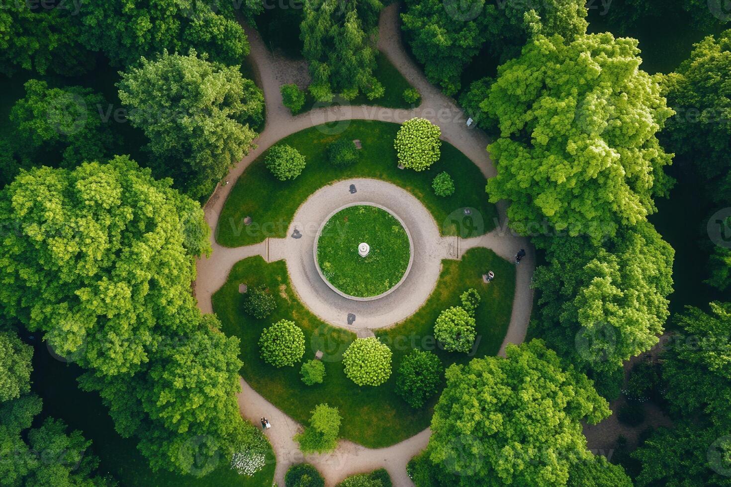 Aerial view of a circular park with lush greenery and winding paths. photo