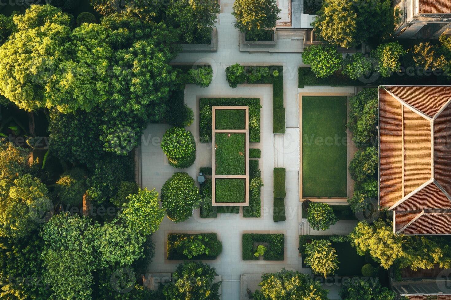 Aerial view of a lush green garden with geometric pathways and a central rectangular lawn. photo