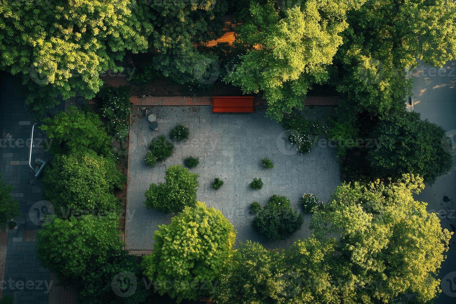 Aerial view of a tranquil park with a bench, surrounded by lush greenery. photo