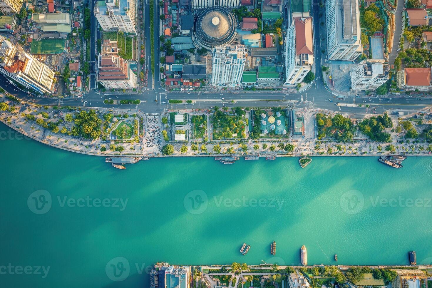 Aerial view of city waterfront with river and green spaces. photo