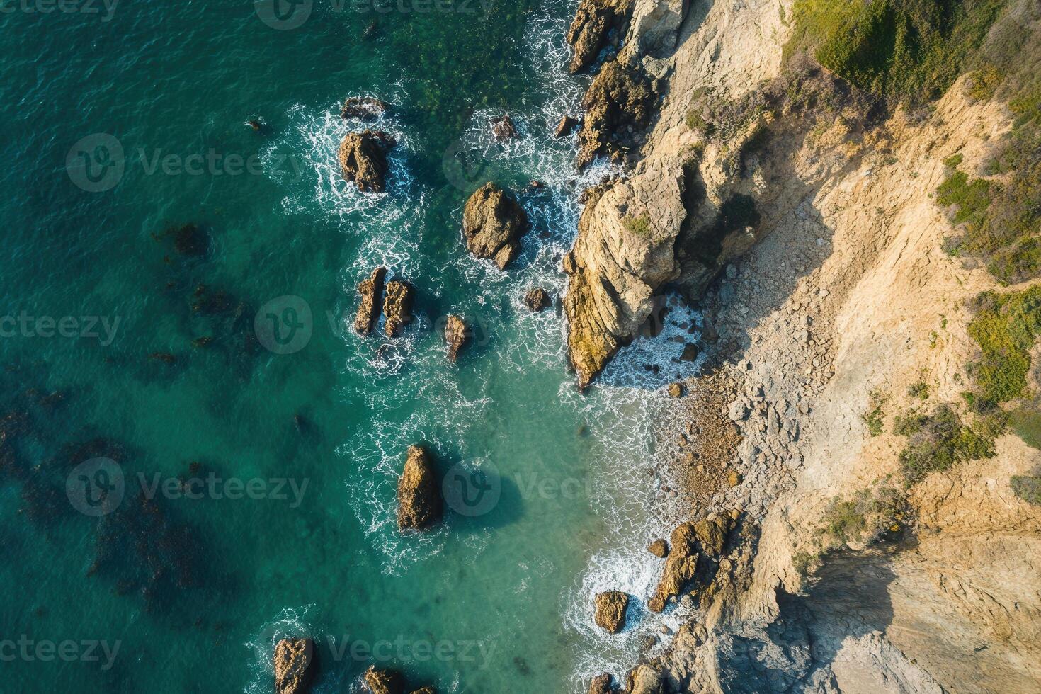 Aerial view of a rocky coastline with clear turquoise water. photo