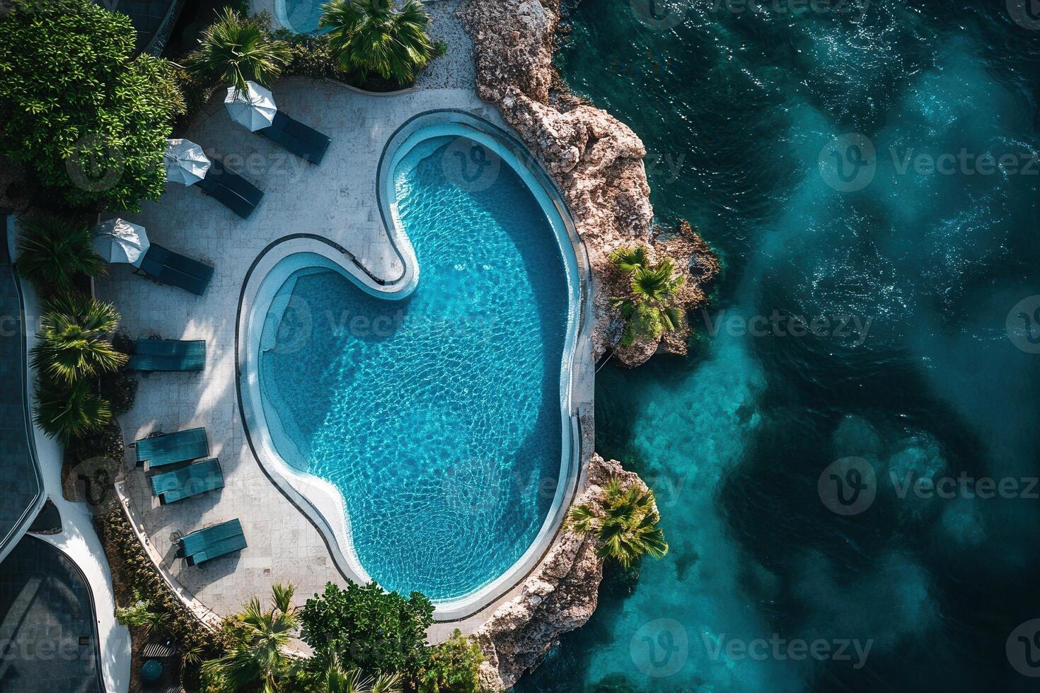 Aerial view of a luxury infinity pool by the ocean. photo