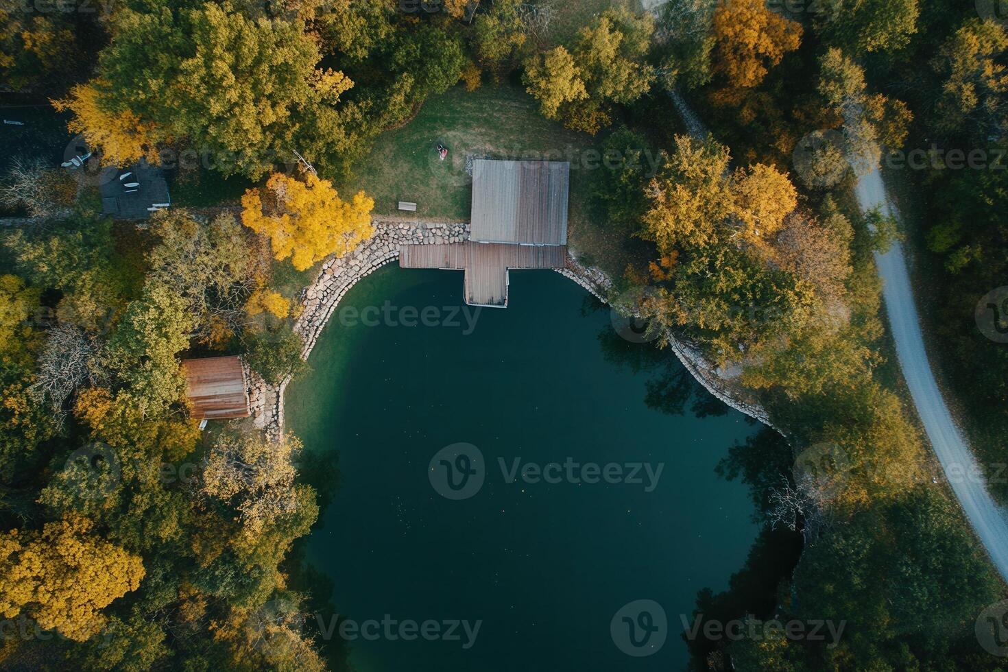 Aerial view of a serene lake surrounded by autumn foliage. photo