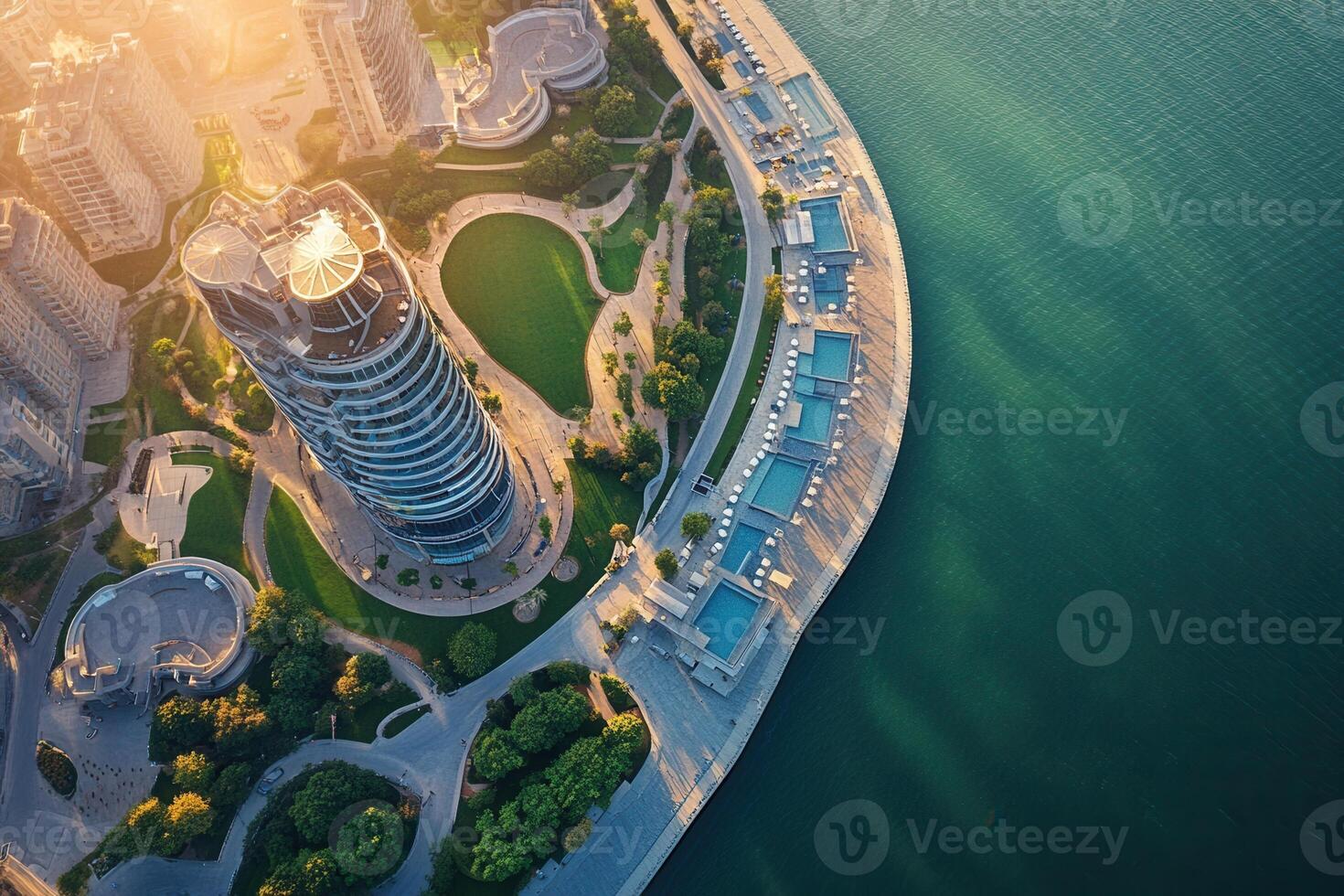 Aerial view of modern cityscape with waterfront park and buildings at sunset. photo