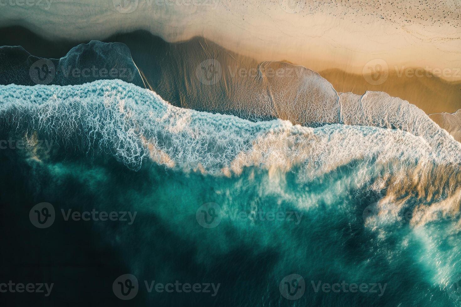 Aerial view of ocean waves crashing on sandy beach at sunset. photo