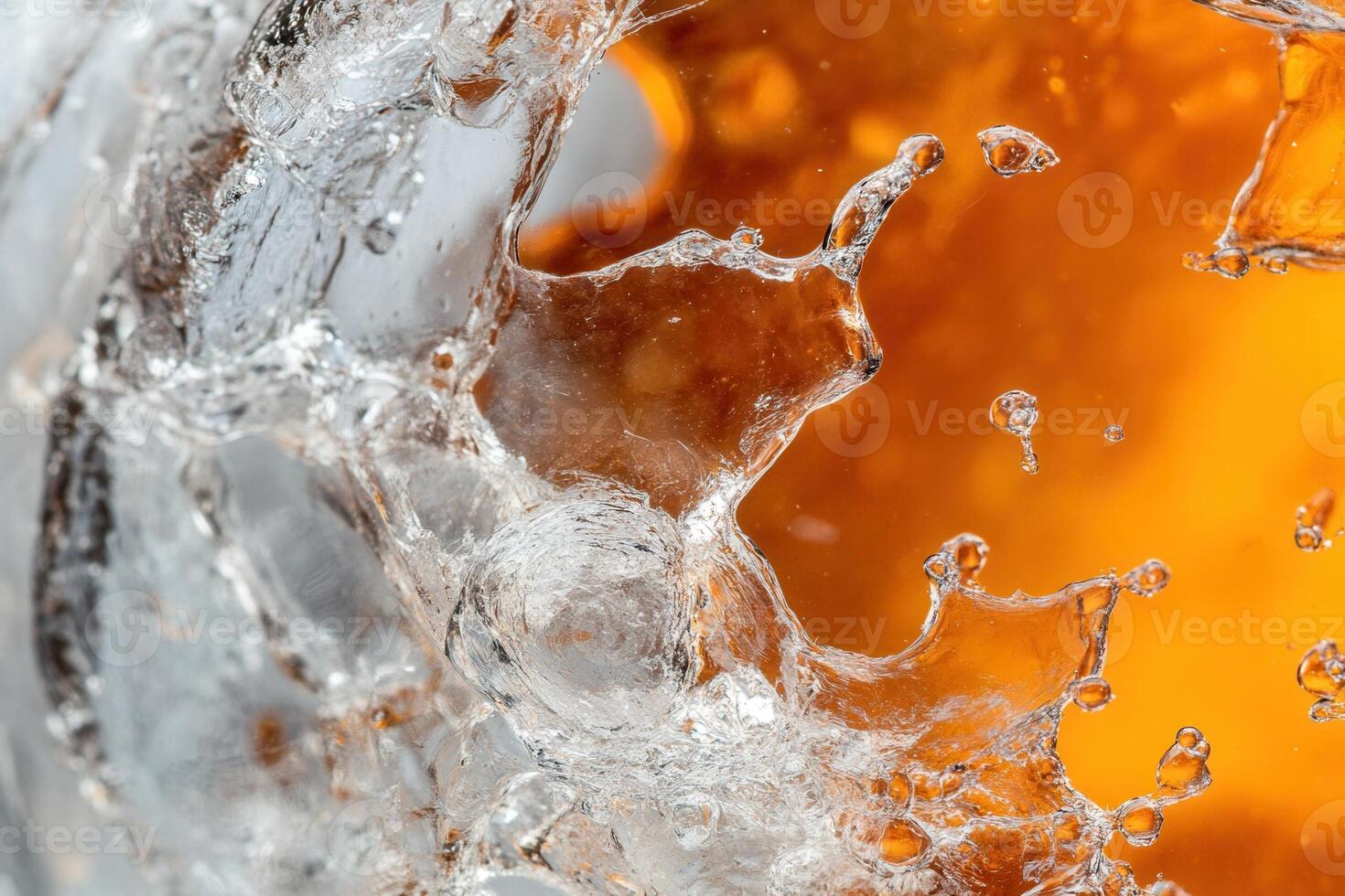 Abstract close-up of amber liquid splashing against ice. photo